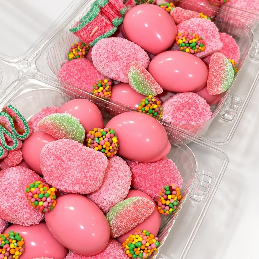The finished trays with pink grapes, sour belts, watermelon gummies and Nerds clusters